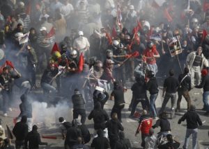 Communists clash with black-clad youths near the Parliament building in Syntagma square in Athens