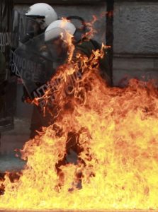 230050-a-riot-police-officer-is-set-aflame-by-a-gasoline-bomb-hurled-at-him-d