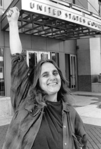 Judi Bari gives the raised fist salute outside the Oakland Federal Courthouse after winning a round in her lawsuit against the FBI and Oakland Police. March 3, 1995, Photo by Xiang Xing Zhou, first published by the San Francisco Daily Journal.
